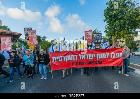 Haifa, Israel - 26. April 2025: Menschen mit verschiedenen Schildern und Flaggen nehmen an einer Protestkundgebung Teil, die die Beendigung des Krieges und die Vollendung der Geiselnahme fordert Stockfoto