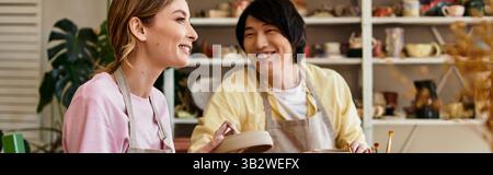 Ein Paar bastelt gemeinsam einzigartige Töpferwaren, die Lächeln und Lachen in ihrem Studio teilen. Stockfoto