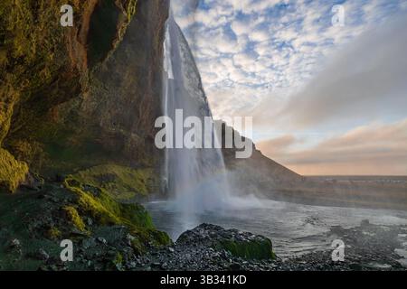 Der majestätische Seljalandsfoss Wasserfall am Nachmittag mit bunten Wolken vor Sonnenuntergang Stockfoto