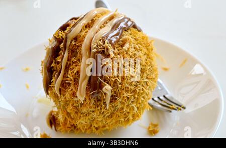 Eiskugel bedeckt mit Kadayif und Schokolade Stockfoto