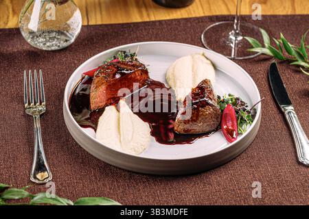 Portion gegrilltes Rindersteak mit Kartoffelpüree Stockfoto