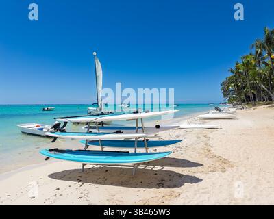 Katamaranboote und Paddelbretter am White Sandy Beach. Wassersportausrüstung an der unberührten tropischen Küste Stockfoto