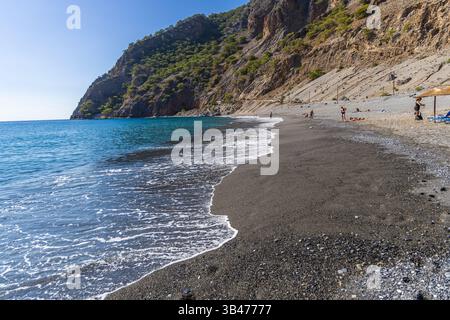 Kreta, Griechenland - 18. Oktober 2024: Abgeschiedener Strand von Agia Roumeli auf Kreta mit malerischer Bergkulisse am Ausgang der Samaria-Schlucht, ein beliebter Ort für hik Stockfoto