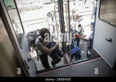 14. September 2015: Flüchtlinge sahen, wie sie in den Zug stürzten, der sie in Richtung Österreich bringen wird. - Die ungarischen Behörden waren auf Züge angewiesen, um Flüchtlinge von der Ungarisch-serbischen Grenze nach Österreich zu transportieren, da sie die Grenze zu Serbien innerhalb der nächsten Stunden schließen wollten. 14. September 2015. (Kreditbild: © Geovien so via ZUMA Wire) Stockfoto