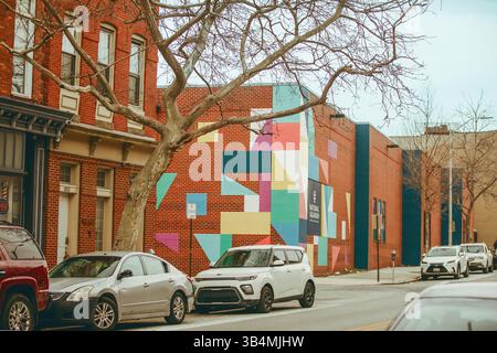 Ein Backsteingebäude mit bunten geometrischen Formen und einem Schild für das National Aquarium in Baltimore, Maryland, USA, 26. Februar 2025. Stockfoto