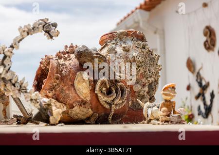 Nahaufnahme einer Sammlung von Vasen und Objekten, die mit Muscheln verkrustet sind. Stockfoto