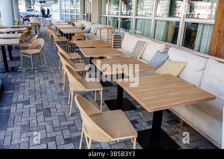 Miami Beach Florida, Außenterrasse des Hotels, Holztische, Metalltischsockel, Rattanstühle, Terrassenmöbel, Sitzbereich im Freien, gepolstertes Sofa ben Stockfoto