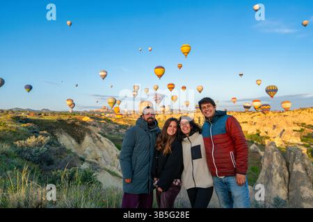 Freunde genießen Heißluftballons, die bei Sonnenaufgang über Kappadokien fliegen Stockfoto