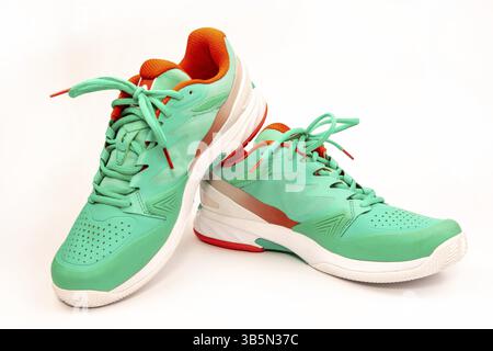 Rote, zyanblaue, weiße Tennisschuhe im Studio, auf weißem Hintergrund Stockfoto