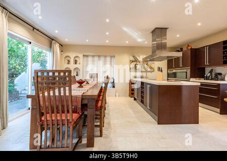 Ein großer hölzerner Esstisch und Stühle in luxuriösen mediterranen Immobilien Stockfoto