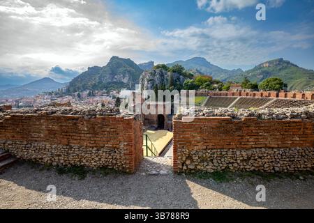 Blick auf das antike griechische Theater in Taormina, Sizilien, Italien, mit atemberaubendem Blick auf die Berge und den Ätna. Stockfoto