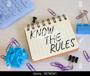 Kennen Sie das Regelsymbol. Konzeptwörter kennen die Regeln für weißes Notizbuch. Schöner Holzhintergrund. Und kennen Sie das Regelkonzept. Kopierbereich. Stockfoto