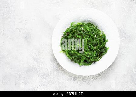 Chuka Salat aus frischem Algen, mit Sesamdressing, serviert auf einem weißen Teller, keine Leute Stockfoto