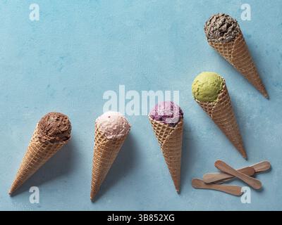 Verschiedene Eis Schaufeln in Kegel mit kopieren. Bunte Eis in der Waffel mit Schokolade, Erdbeere, Heidelbeere, Pistazien oder Matcha, Kekse chocola Stockfoto