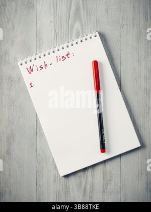 Weihnachtsgeschenke einkaufen Planung. Shopping, Merkzettel, oder - Liste für Weihnachten tun. Notebook mit Rot auf grau Holz- Hintergrund. Kopieren Sie Platz. Stockfoto