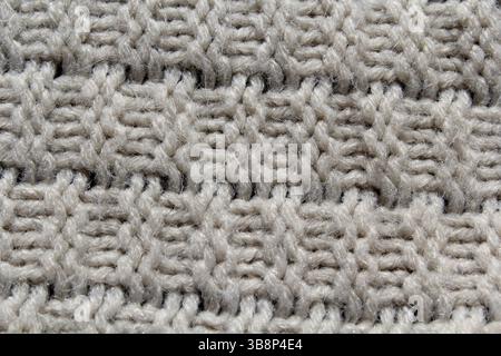 Nahaufnahme eines abstrakten texturierten Hintergrunds aus gestricktem Stoff Stockfoto