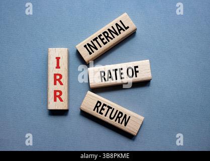 IRR - Internal Rate of Return symbol. Concept word IRR on wooden cubes. Beautiful grey background. Business and IRR concept. Copy space. Stockfoto