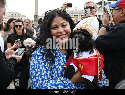 Eine Frau posiert mit ihrem Hund Romeo, gekleidet als Papst, am zweiten Tag des Konklaves im Vatikan am 8. Mai 2025 auf dem Petersplatz. Die 133 Kurfürsten haben die Sixtinische Kapelle betreten, um das Konklave zu besuchen, das den nächsten und den 267. Papst wählen wird. Foto: Eric Vandeville/ ABACAPRESS.COM Credit: Abaca Press/Alamy Live News Stockfoto