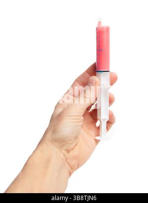 Handspritze mit flüssigem Amoxicillin. Amoxicillin Suspension zum Einnehmen Dosis in einer Spritze. Penicillin-Antibiotikum bei Kinderärzten und Zahnärzten Stockfoto