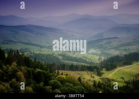 Wunderschöner Himmel und Wald hoch oben in den Karpaten. Mit Blick auf das Dorf nach Regen mit Sonnenstrahlen Stockfoto