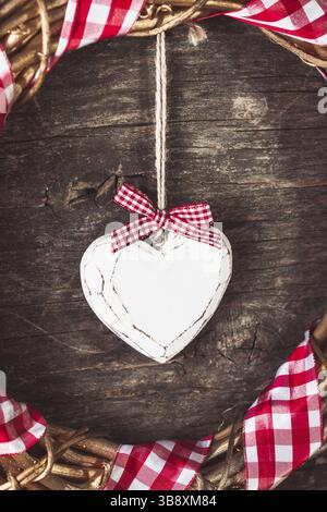 Weißes Herz und Kranz auf altem Holzhintergrund Stockfoto