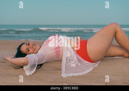 Frau, die sich am Strand entspannt und im Sommer getragen hat Stockfoto
