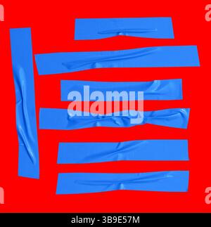 Draufsicht Set aus zerknittertem oder zerknittertem blauem Vinylklebeband oder Stoffband in Streifenform ist auf rotem Hintergrund mit Beschneidungspfad isoliert. Stockfoto