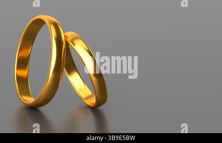 Zwei goldene Eheringe auf dunklem Hintergrund mit leerem Raum Stockfoto