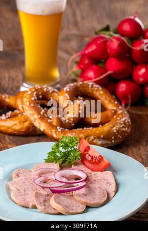 Bayerischer Wurstsalat auf dunklem Holz Stockfoto