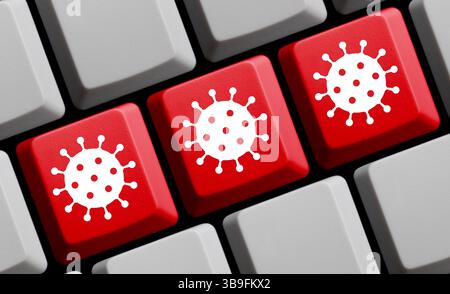 Rote Computertastatur mit Coronavirus-Symbol Stockfoto