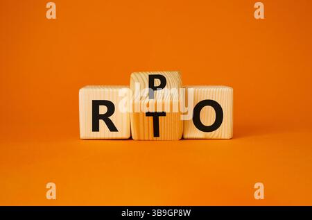RPO vs. RTO-Symbol. Holzwürfel mit den Worten RTO zu RPO gedreht. Wunderschöner orangefarbener Hintergrund. Geschäftskonzept. Kopierbereich Stockfoto