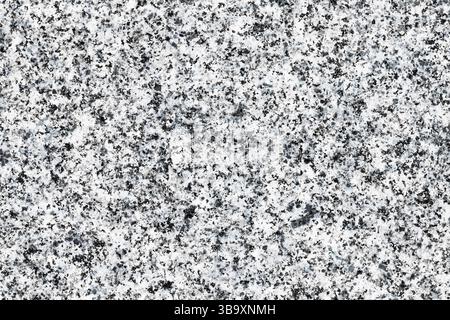 Nahaufnahme der Granitsteinstruktur. Detaillierte Ansicht der natürlichen Mineraloberfläche. Struktur aus schwarzem und weißem Stein. Geologische und erdwissenschaftliche Hintergründe. Abs Stockfoto