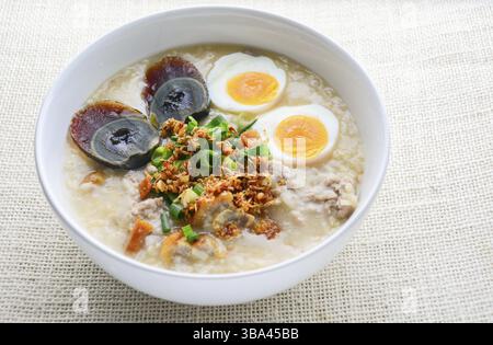 Congee, Reisbrei mit Hackfleisch vom Schwein, gekochten Ei und Century Ei, super zum Frühstück Stockfoto
