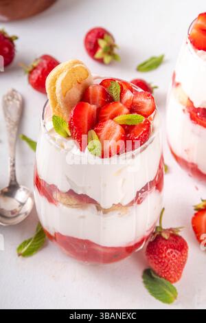 Sommer-Erdbeer-Tiramisu-Dessert, Beerenfrucht-Version des Sommer-Tiramisu-Kuchens in Glasgläsern mit frischer Erdbeere, Mascarpone und Savoyardi Stockfoto