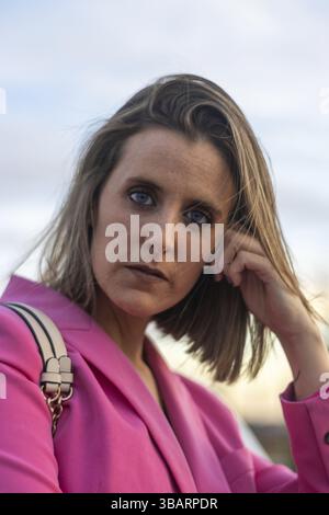 Nahaufnahme einer erwachsenen blonden Frau, die draußen in die Kamera schaut Stockfoto