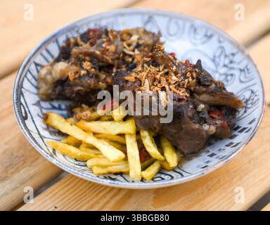 Köstliches geschmortes Fleisch mit knusprigen Pommes frites Stockfoto