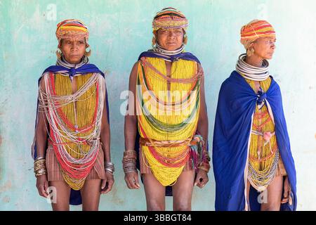 Frauen aus dem Stamm Bonda in farbenfroher traditioneller Kleidung und wunderschönen Halsketten posieren für ein Foto in einem kleinen Dorf im ländlichen Orissa, Indien Stockfoto