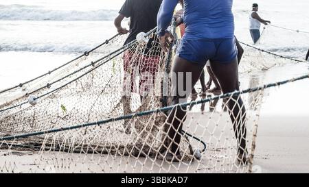 Ein halber Körper von nicht identifizierten Fischern, die ein Fischernetz ziehen. Angelsport. Brasilien Stockfoto