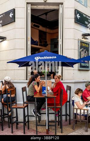 Leute, die während des San Telmo Sunday Market, San Telmo District, Buenos Aires, Argentinien, vor Einem Café/Bar in der Plaza Dorrego sitzen. Stockfoto
