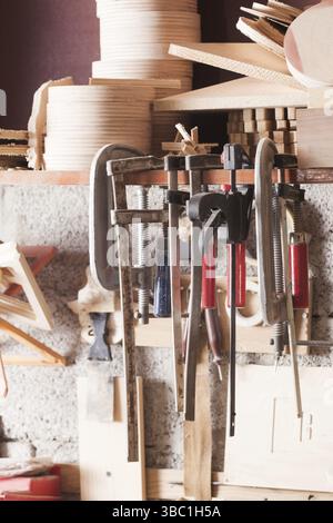 Die alten Werkzeuge des Zimmermanns, die in der Werkstatt an der Wand befestigt wurden. Nahaufnahme des Sets verschiedener Werkzeuge und Instrumente, die in der Zimmereiwerkstatt an der Wand befestigt sind Stockfoto