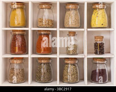 Sortiment von trockenen Gewürze in vintage Glas Flaschen in Holzkiste Stockfoto