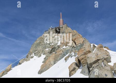 Ein Blick auf die Menschen auf einer Aussichtsplattform auf der Spitze der Seilbahnstation Aiguille du Midi über der französischen Bergstadt Chamonix an einem sonnigen Tag. Stockfoto