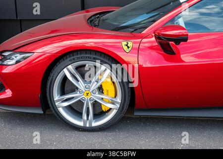 Close up detail from side view of a Red Ferrari  sports car produced by the Italian automobile manufacturer Ferrari. Copenhagen, Denmark - May 15, 202 Stockfoto
