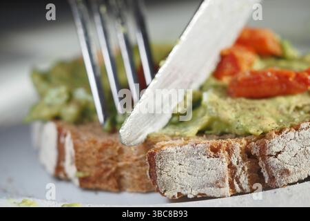 In einen frischen Avocado-Toast auf Vollkornbrot schneiden Stockfoto