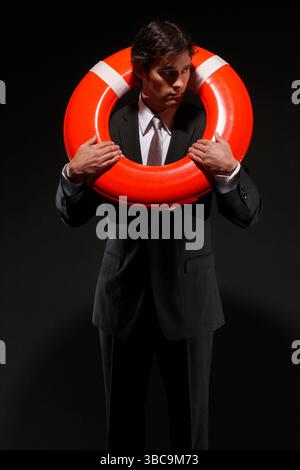 Businessman with life-preserver Stockfoto