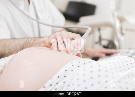 Das Foto zeigt eine Ultraschalluntersuchung einer schwangeren Patientin Stockfoto