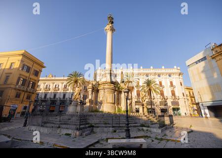 Die Sonne am frühen Morgen erleuchtet die Säule und die barocken Skulpturen auf der Piazza San Domenico in Palermo, Sizilien. Dieses Bild zeigt zeitlosen europäischen Charme und ist ideal für Reisen, Geschichte und Architektur Stockfoto