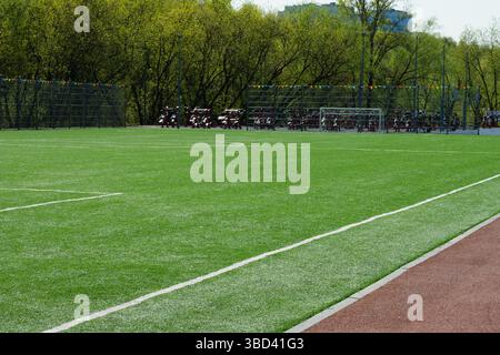 Soccer goal on big field with artificial green grass. Outdoor sports activities. Sports ground, field with artificial turf for playing soccer and othe Stockfoto
