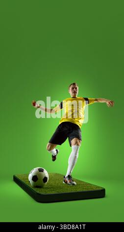 Übertragungen von Sportwettbewerben. Composite Collage. Professioneller männlicher Fußballspieler, der Ball auf 3D-Handy-Bildschirm vor grünem Hintergrund tritt. Stockfoto