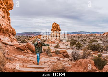 Lächelnde Frau, die durch die Red Rock Landscape in Utah wandert Stockfoto